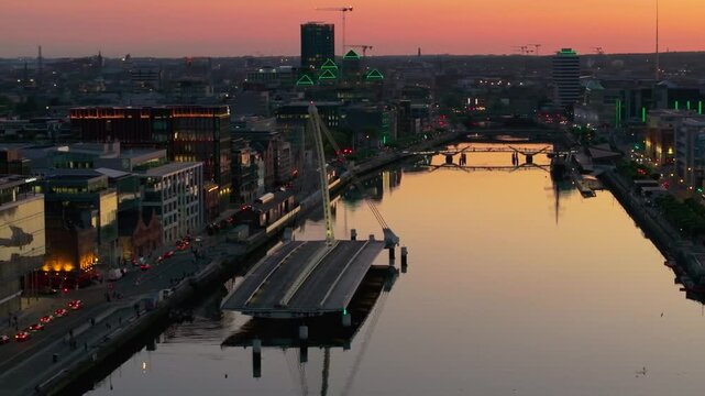 4K cinematic drone footage capturing a golden sunset over Dublin&rsquo;s Samuel Beckett Bridge during a rare moment when it&rsquo;s open, with stunning reflections on the River Liffey. Co. Dublin, Ireland_222