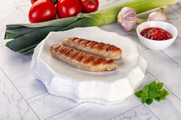 Grilled pork sausages served tomato sauce