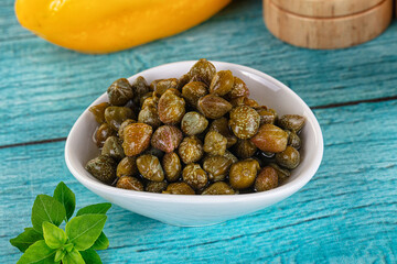 Pickled canned capers in the bowl