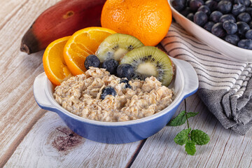 Oats porridge with blueberry, kiwi and orange