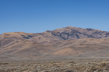 Basalt (Pleistocene and Pliocene) Lava Flows with Pioneer Mountains. U.S. Highway 20 (US 20)  / U.S. Highway 26 (US 26) , Martin
, Butte County, Idaho. Snake River Plain. 
