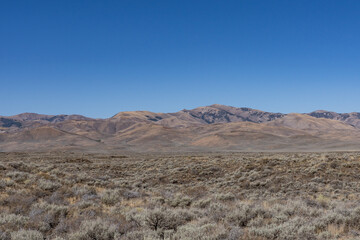 Basalt (Pleistocene and Pliocene) Lava Flows with Pioneer Mountains. U.S. Highway 20 (US 20)  / U.S. Highway 26 (US 26) , Martin
, Butte County, Idaho. Snake River Plain. 
