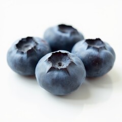 Obraz premium Four blueberries are shown in a close up