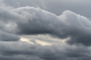 Dramatic storm clouds for the background. Isolated summer storm clouds before a thunderstorm. Dark storm clouds before the rain. Bad weather. A heavenly landscape of clouds in the sky on a rainy day.