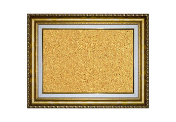 Wooden and gold gilded ornamental frame with rectangular beige cork board
