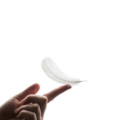 Delicate White Feather Balanced on a Finger Against Black Background