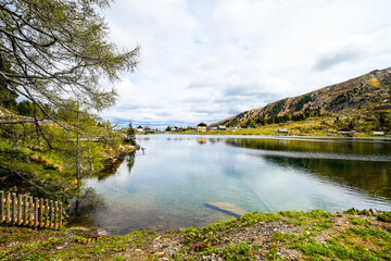 Fototapeta premium View of Lake Falkert in the Gurktal Alps and the surrounding landscape. Nature at a mountain lake in Carinthia. High mountain lake in Austria. 