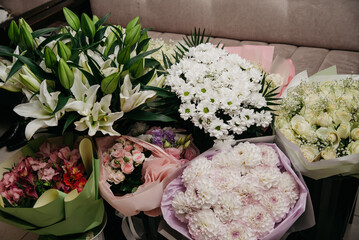 Various flower bouquets in large vases at a wedding or other celebration