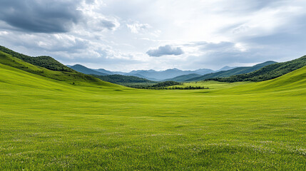 Fototapeta premium Lush green hills under dramatic cloudy sky create serene landscape