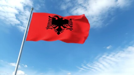 The National Flag of Albania Waving in the Wind Against a Blue Sky.