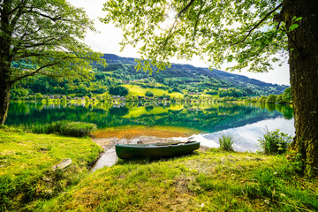 Landscape at Lake Feldsee in Carinthia. Nature at an idyllic lake in Austria with mountains in the background.
