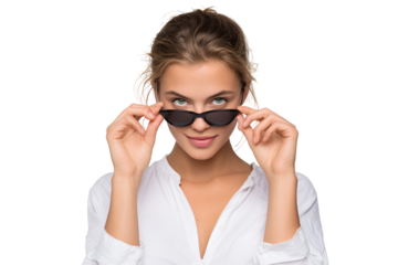 Confident woman adjusting fashionable sunglasses portraying a playful attitude with a modern touch creating intrigue and inviting the audience to explore the possibilities she