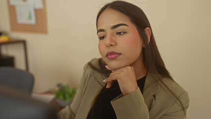 Woman thinking at desk in an office, deep in thought, adds a touch of professionalism and...