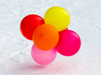 A bunch of balloons in different colors are on the ground