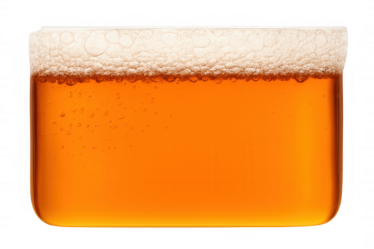 Refreshing golden beer with frothy white foam and rising bubbles in a pint glass, transparent background