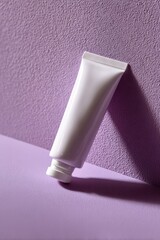 Moisturizer Tube on a Lilac Surface with Subtle Shadows for Beauty Use
