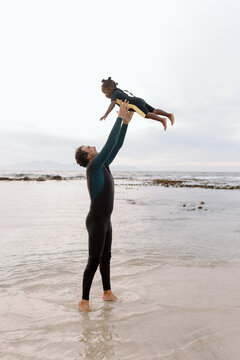 Father throwing daughter in air