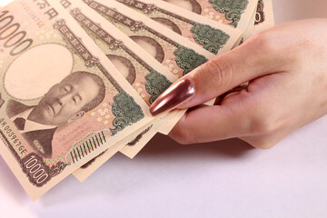 1万円札と女性の手