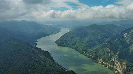 Aerial view on Danube river and mountains under clouds