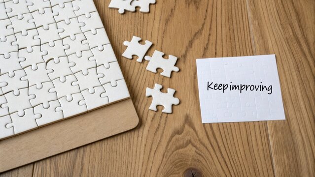 Inspirational message on a note with a puzzle arrangement symbolizing personal growth and continuous improvement in life