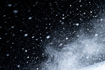 Snowflakes falling in night sky