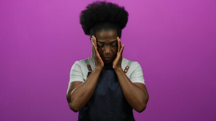 Woman appearing thoughtful wearing an apron against a vibrant pink background, embodying an...