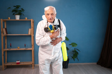 portrait of Grateful Elderly pest control worker with hands on heart inside infested house....