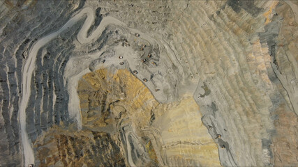 Aerial of open mine and heavy mining equipment