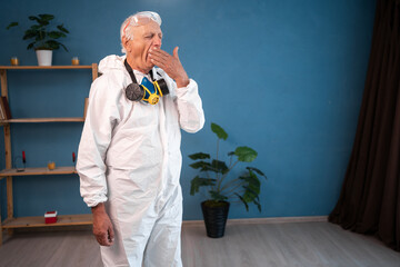 tired and yawning Elderly pest control worker burnout, exhausted and lazy inside infested house....
