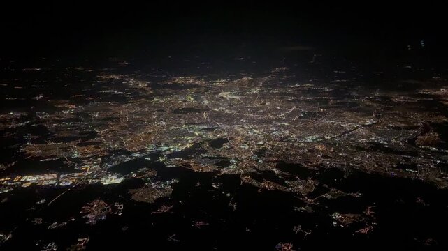 4k aerial footage - Paris, capital of France, aerial view during night time - brightly illuminated,  with central downtown part of the city with river "Seine",  illuminated buildings and streets