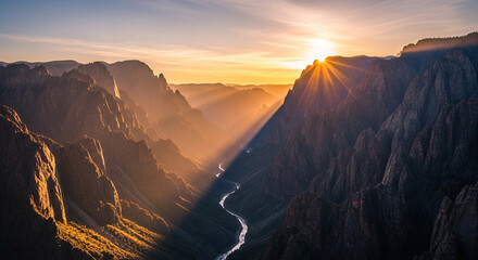 Spectacular sunrise over the black canyon of the gunnison national park with sun rays shining through the canyon walls in colorado