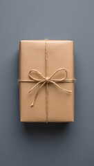Aesthetic gift box with brown paper and twine on a gray background for special occasions and holidays