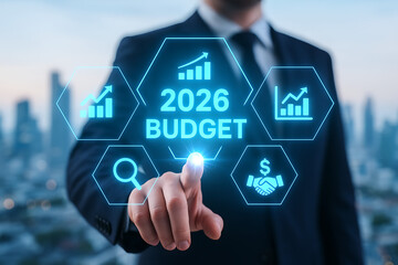 2026 budget financial planning and analysis with businessman touching holographic screen, representing future corporate growth and economic forecast goals