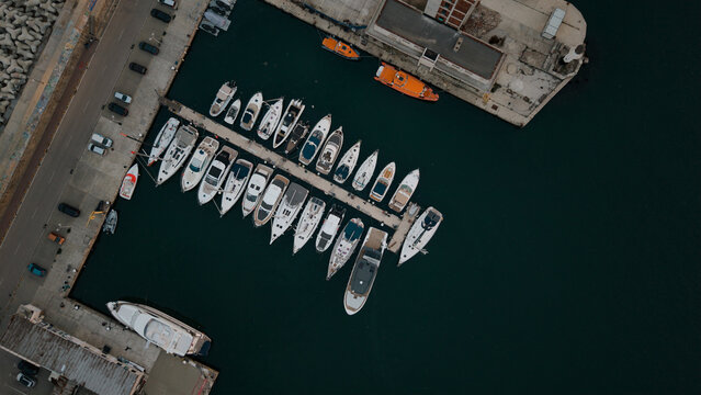 Aerial top view of yachts and boats docked at marina pier in Varna, Bulgaria.