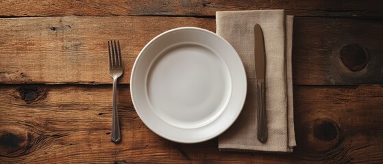 The Plate on Rustic Wooden Table with Fork and Knife on Napkin