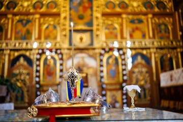 Orthodox wedding crowns and cross on altar inside Romanian church