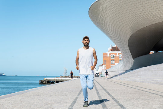 Runner exercising by the Maat in Lisbon during a summer morning