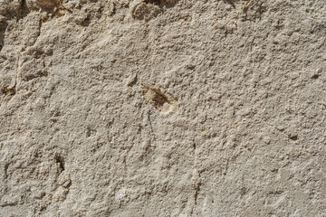 Cracked and weathered stone plaster wall for rustic building and texture background concept