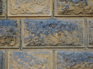 Historic rusticated stone wall with irregular, rough blocks. Close-up. Copyspace.