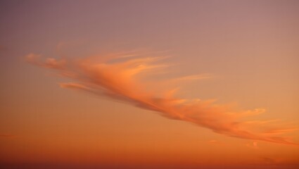 Softly lit cloud formation in a warm sunset sky