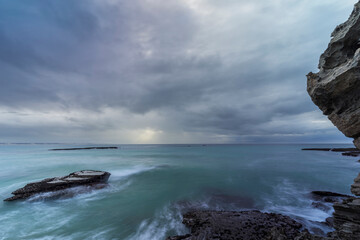 Marine view of Arniston&rsquo;s stunning rocky coastline in Overberg, Western Cape, South Africa. Dramatic shore, textured rocks and tranquil sea create a scenic coastal landscape for travel and nature.