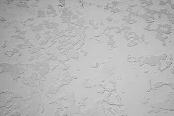 White textured plaster wall with uneven artistic surface and rough patchwork