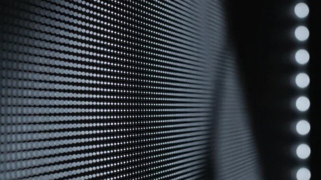 A close-up view of a digital display panel with numerous small lights, creating a modern and technological background.