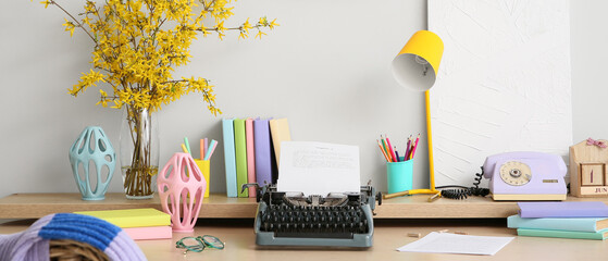 Workplace with typewriter on table in room