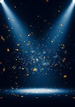 An empty stage illuminated by two bright spotlights with golden confetti falling through the air.
