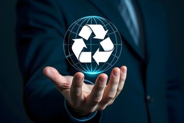 Man holding a glowing recycle symbol in his hand with a globe behind it on a blue background