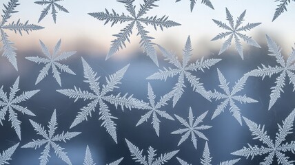 Close-up view of intricate frost patterns resembling snowflakes on a window pane.