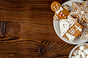 Christmas gingerbread, spruce branches on wooden background top view