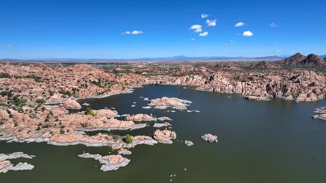 Aerial view of Watson Lake's granite dells contrasting with the lake's dark waters, nestled in the arid landscape, Watson Lake, Prescott, Arizona, United States.