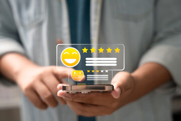 Customer giving 5-star rating on smartphone screen with smiley emoji icon, symbolizing excellent user feedback, satisfaction review, and positive digital reputation.